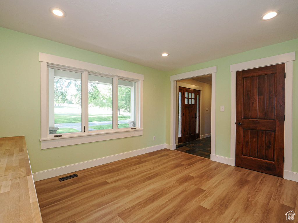 Unfurnished room featuring light wood finished floors, recessed lighting, and baseboards