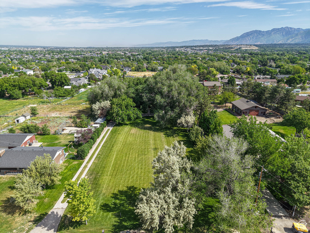 View of property location featuring mountains and a tree filled landscape