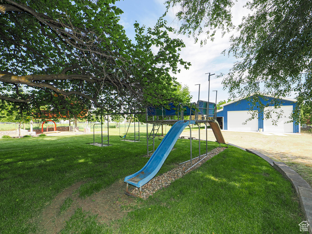 Community playground with a yard and an outdoor structure