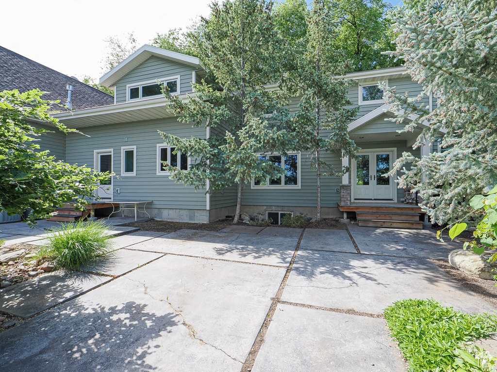 Rear view of property with french doors
