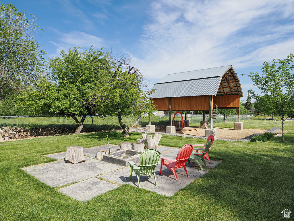View of yard featuring a fire pit and a gazebo