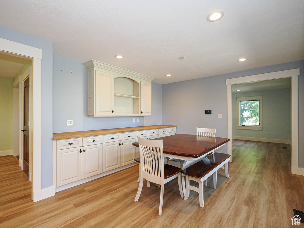 Dining space featuring light wood-type flooring, baseboards, and recessed lighting