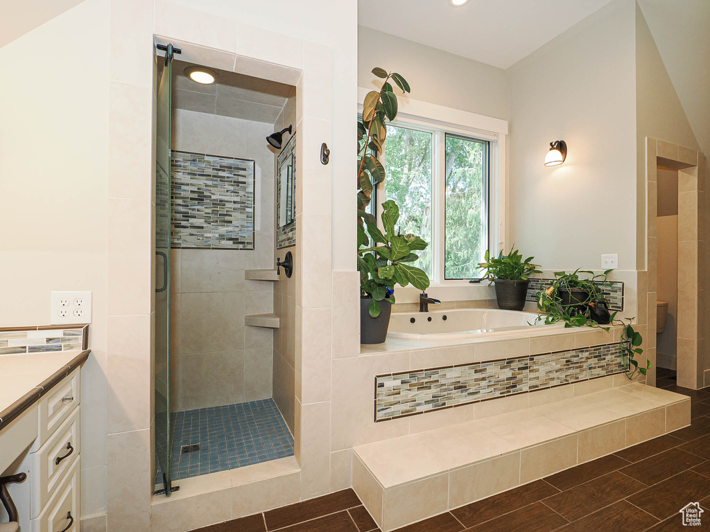 Bathroom with a garden tub, a shower stall, vanity, and recessed lighting