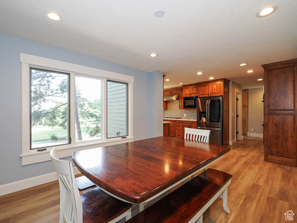 Dining room featuring baseboards, recessed lighting, and light wood-style floors