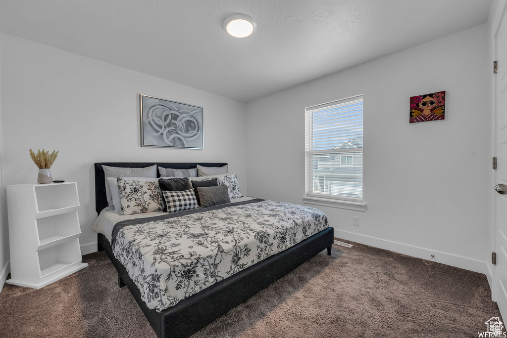 Bedroom featuring carpet flooring and baseboards