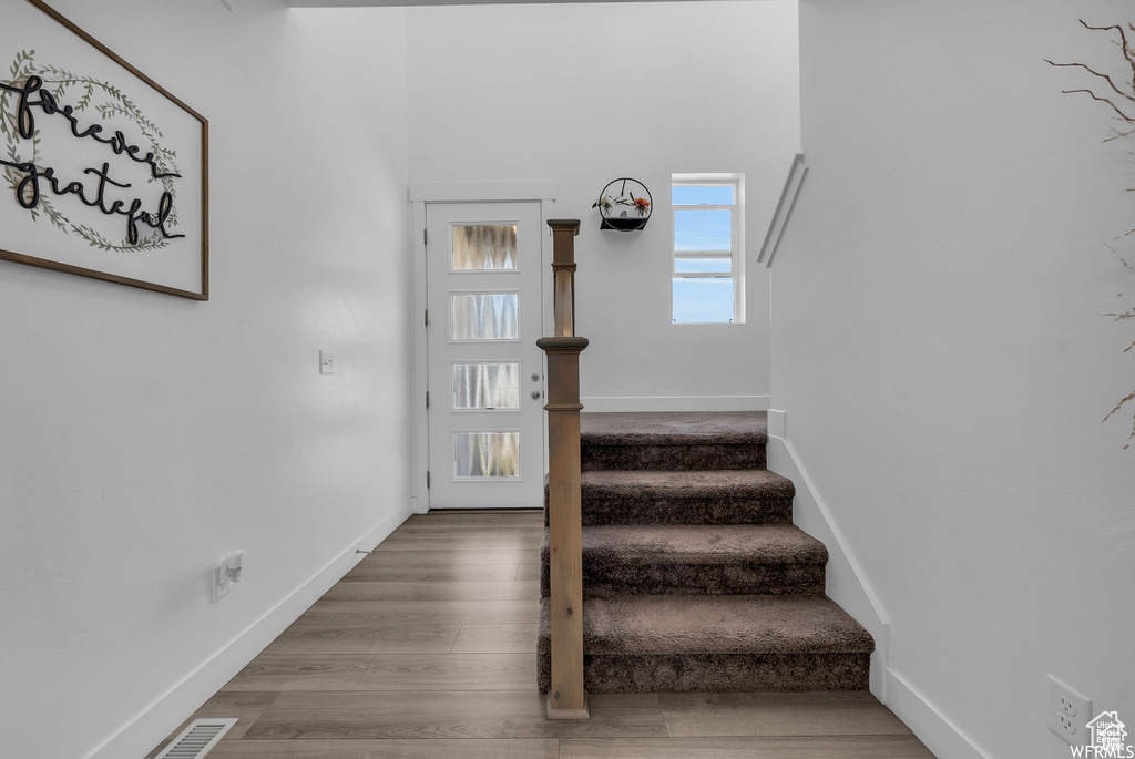 Staircase featuring wood finished floors and baseboards