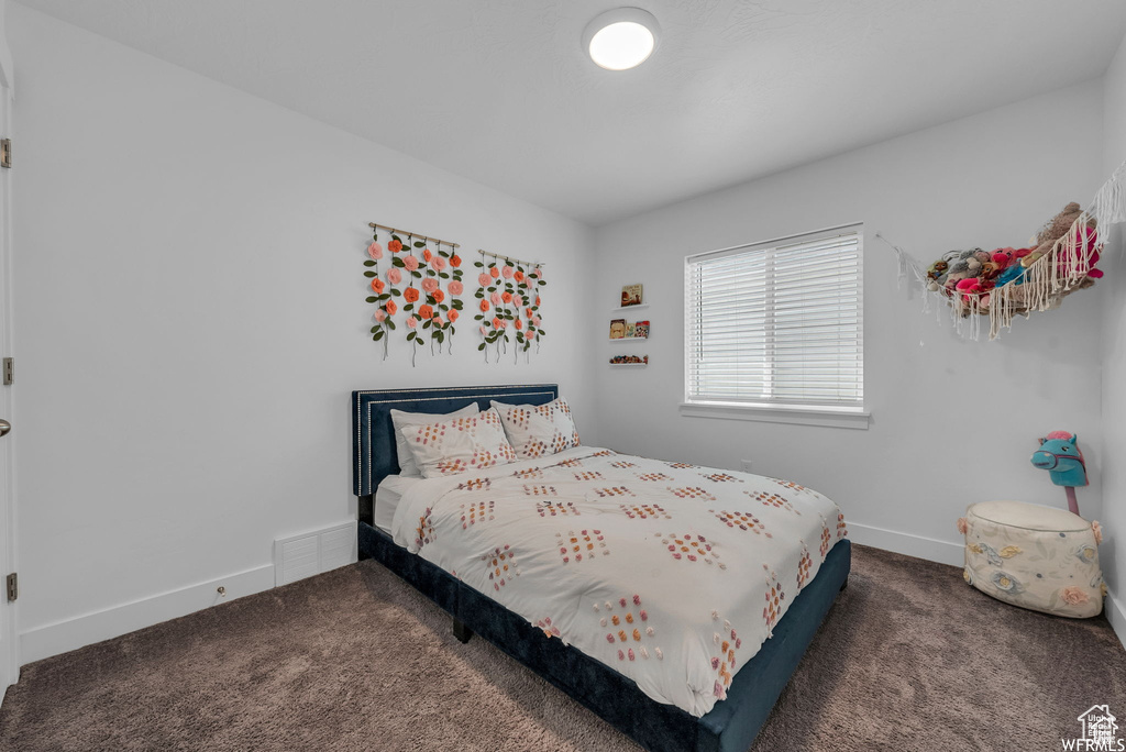 Carpeted bedroom with baseboards