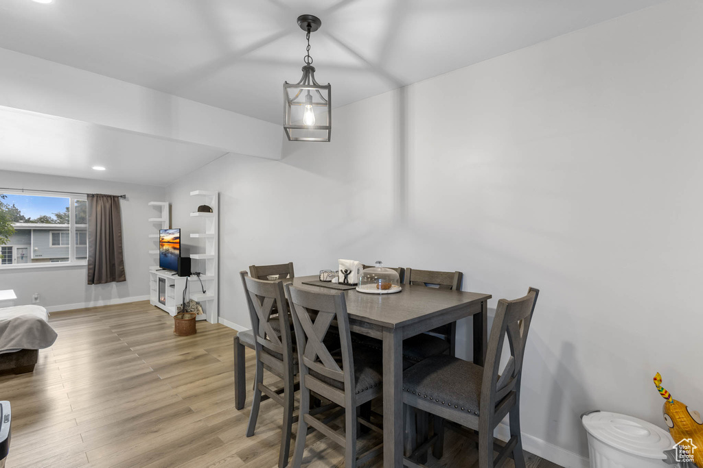 Dining space with light wood-style flooring, baseboards, and recessed lighting