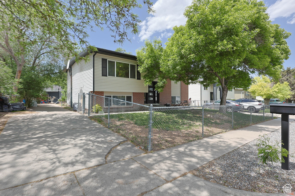View of front of house featuring brick siding and a fenced front yard