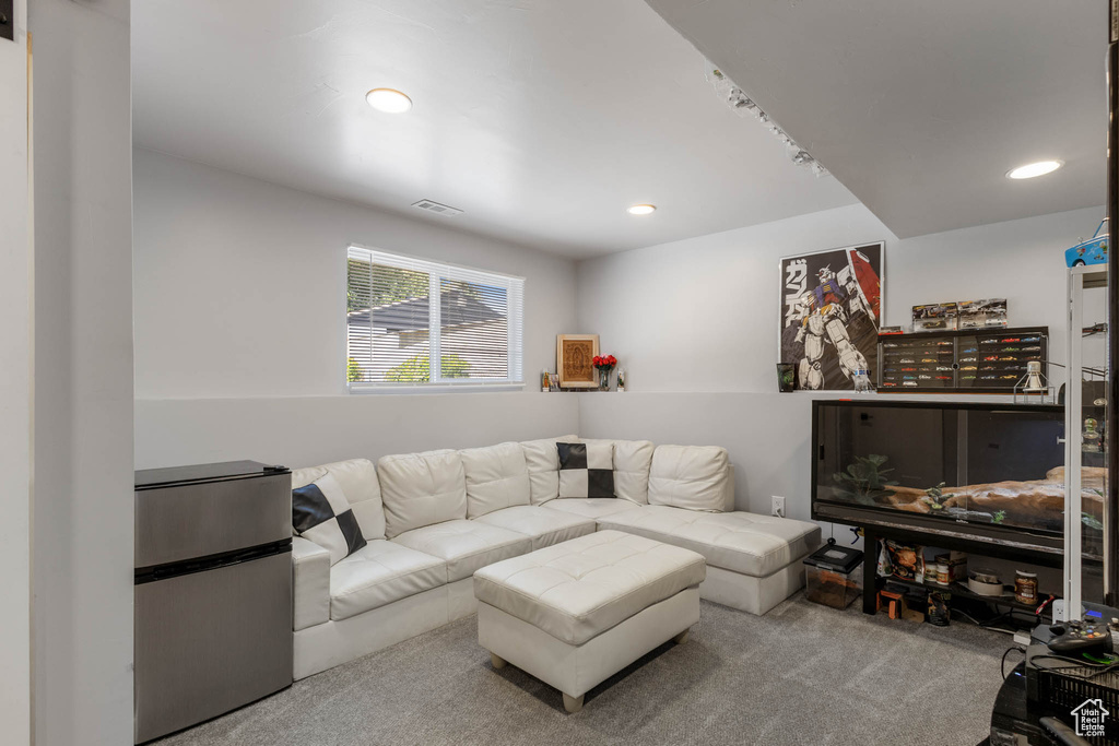 Living room with carpet flooring and recessed lighting