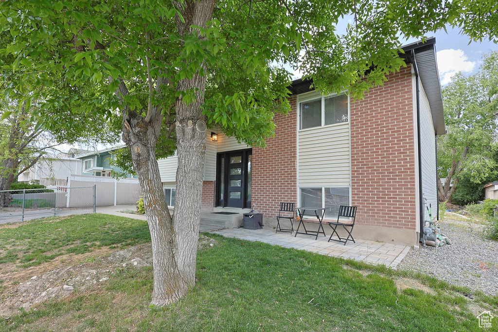 Rear view of house featuring brick siding