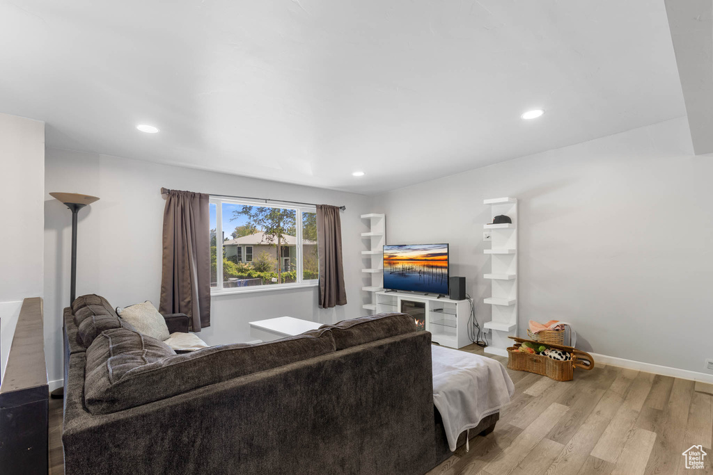 Living room with wood finished floors, recessed lighting, and baseboards