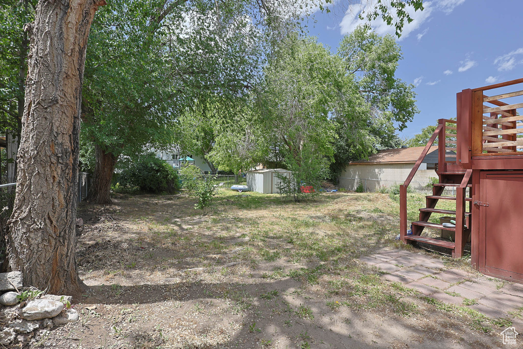 View of yard featuring stairway and a deck