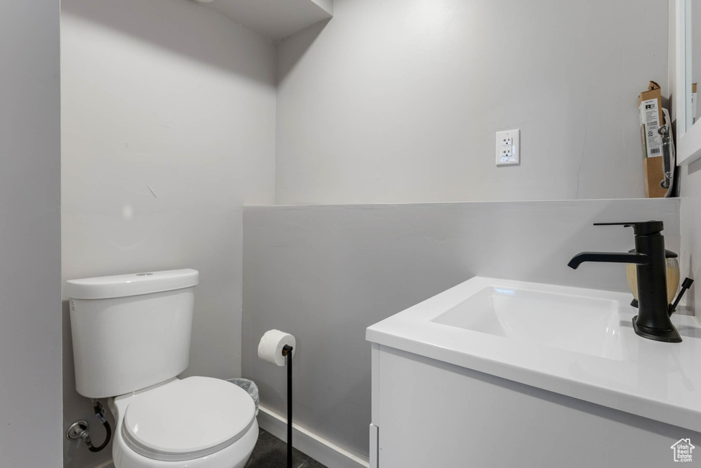 Half bathroom with vanity and toilet