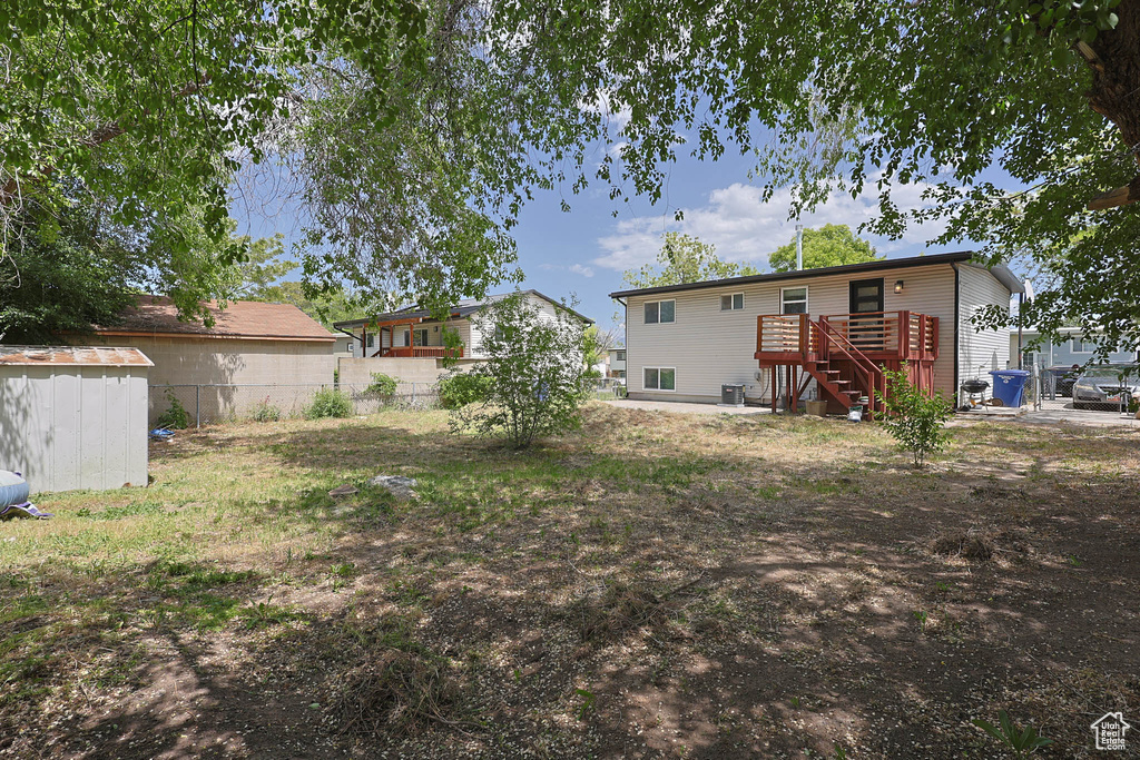 View of yard featuring stairs and a wooden deck