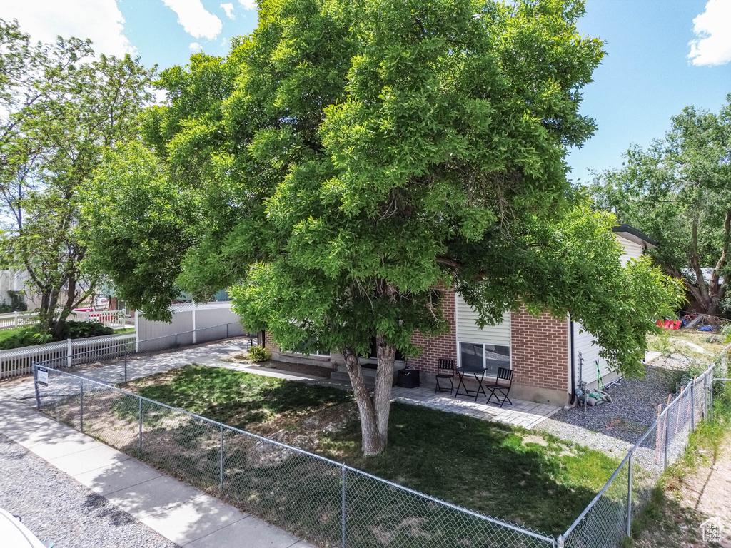 View of front of property featuring a patio area and a fenced backyard