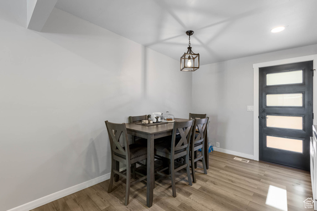 Dining area featuring baseboards, wood finished floors, and recessed lighting