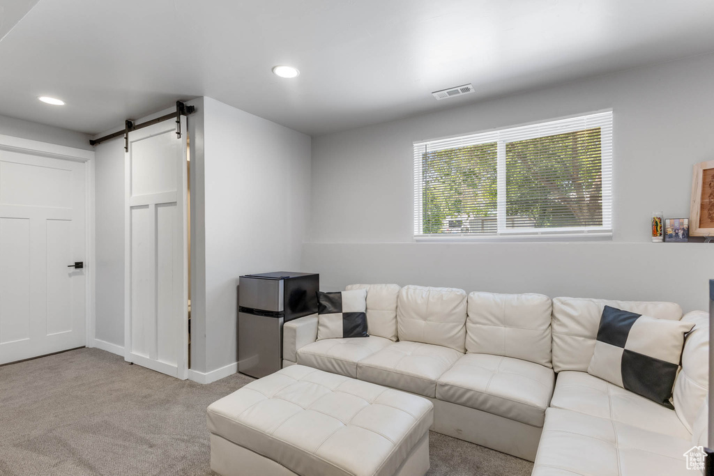 Living room with carpet, a barn door, recessed lighting, and baseboards