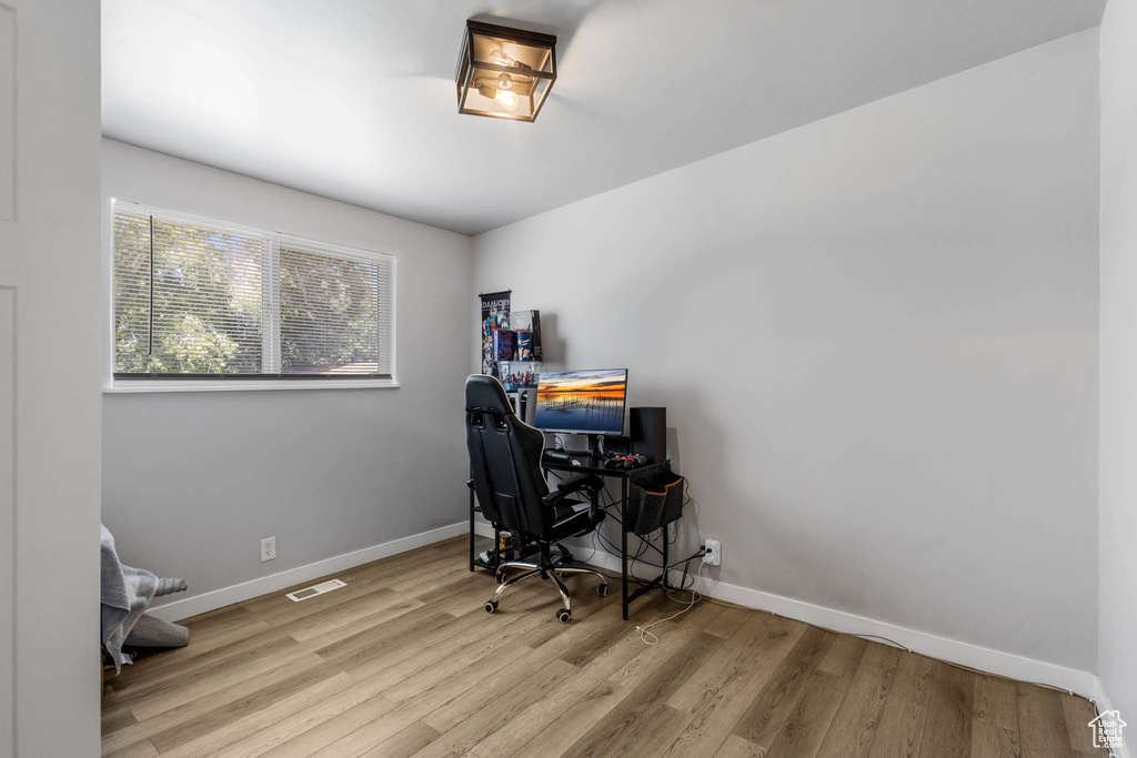 Home office with wood finished floors and baseboards