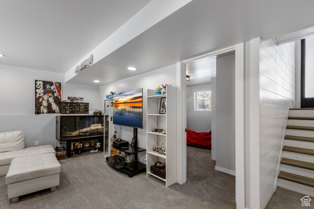 Carpeted living room featuring stairway and recessed lighting