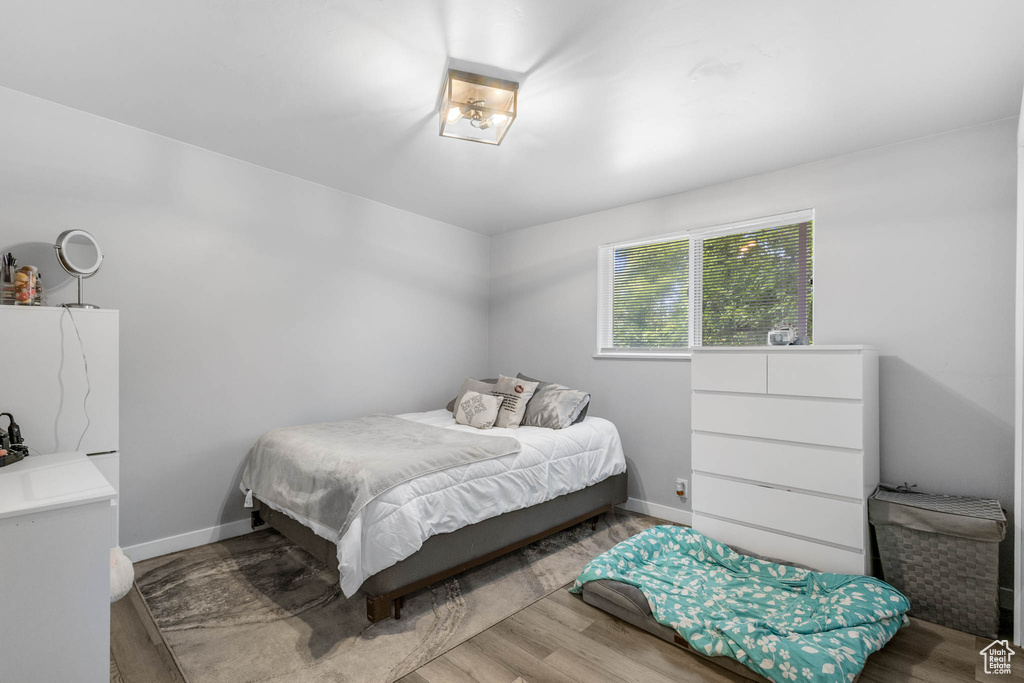 Bedroom featuring wood finished floors and baseboards