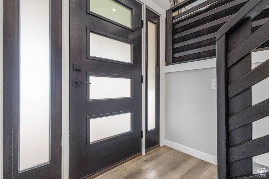 Entrance foyer featuring light wood-type flooring and baseboards