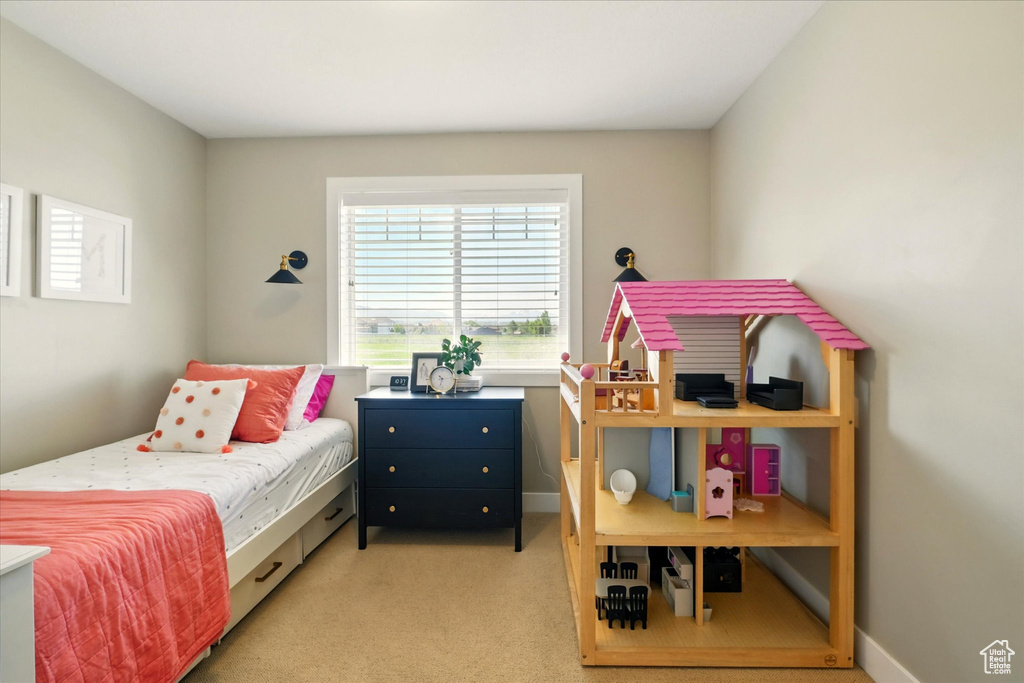 Bedroom featuring light carpet