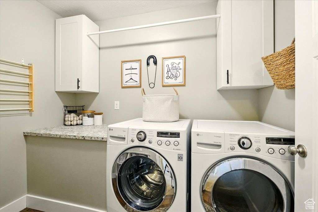 Washroom with washing machine and clothes dryer and cabinet space