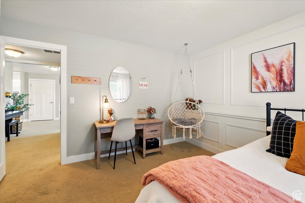 Bedroom featuring light colored carpet and baseboards