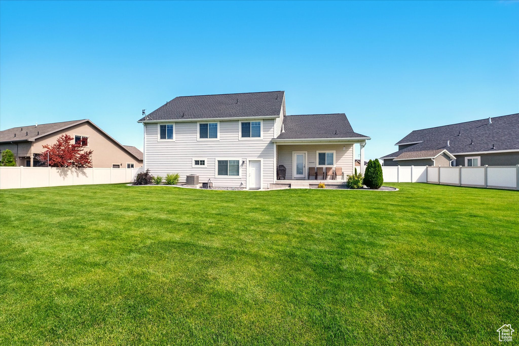 Back of property featuring a patio, cooling unit, and a shingled roof