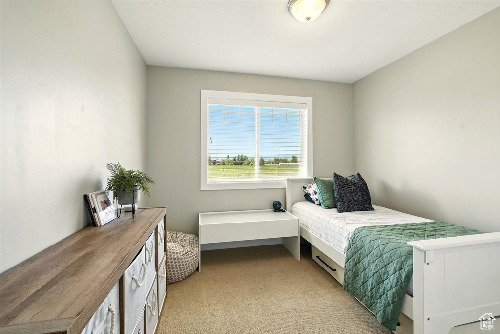 Bedroom with light colored carpet