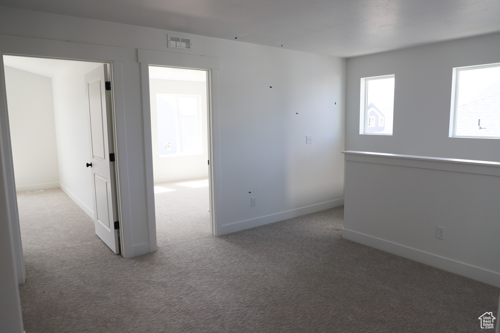 Unfurnished room featuring carpet floors and baseboards