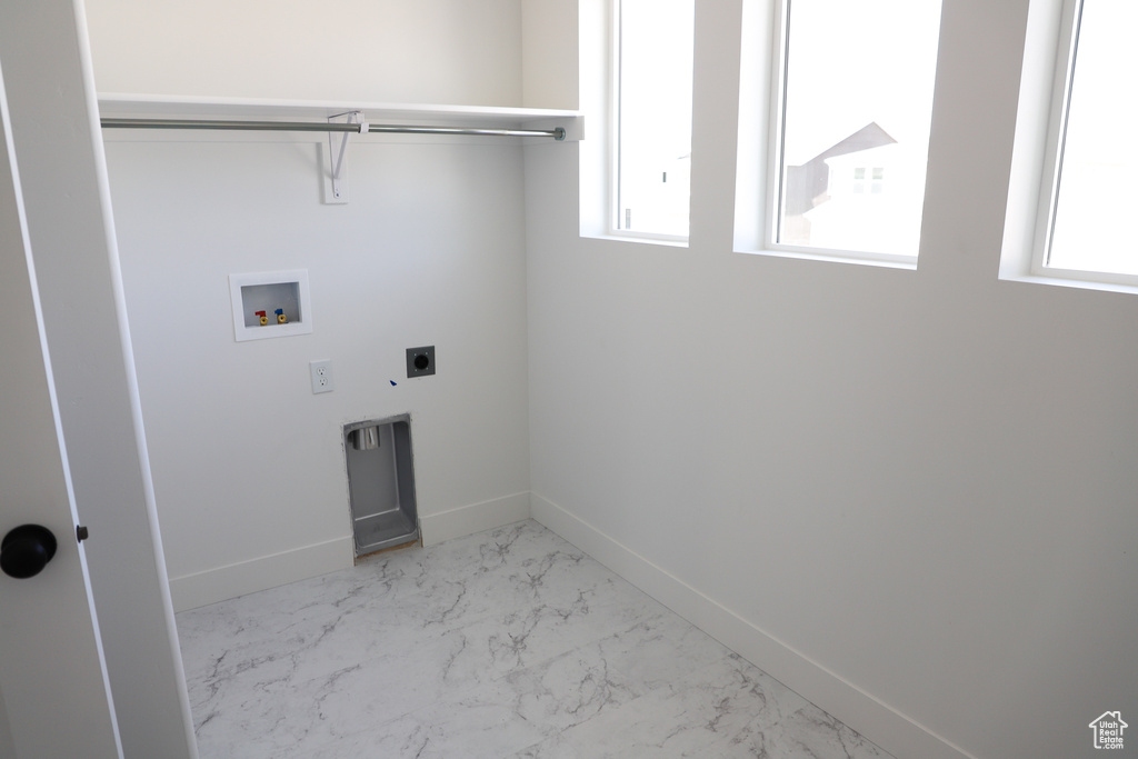 Washroom featuring hookup for a washing machine, electric dryer hookup, baseboards, and marble finish flooring