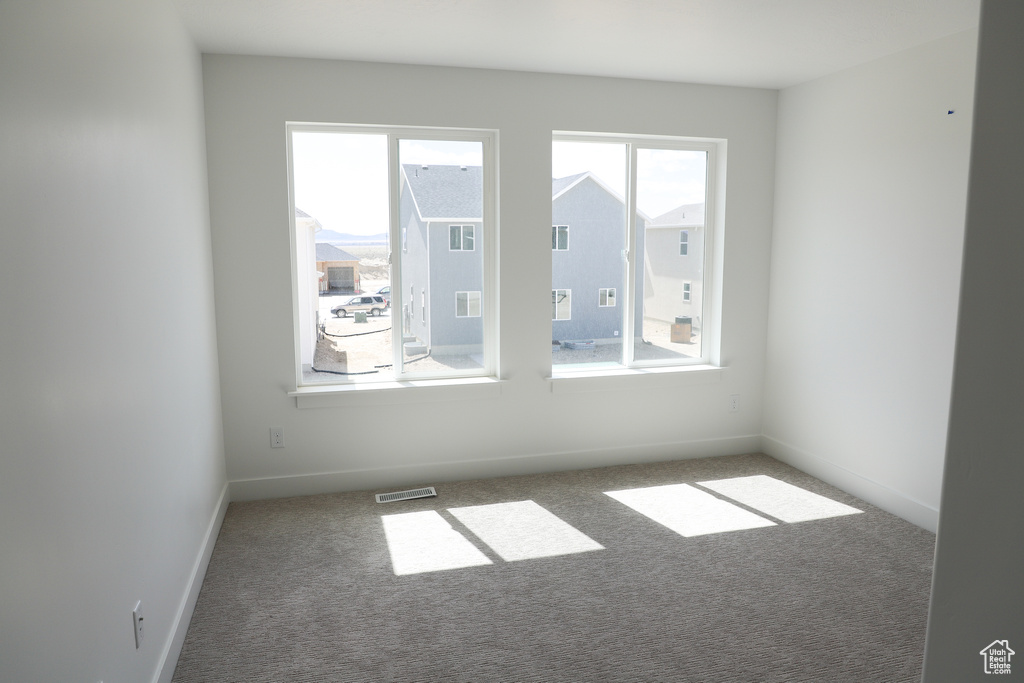 Unfurnished room with carpet floors and baseboards