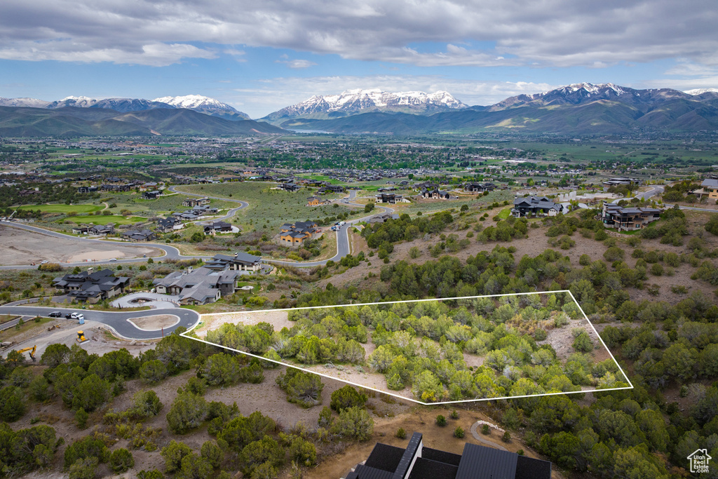 View of property location with a mountainous background and property boundaries highlighted