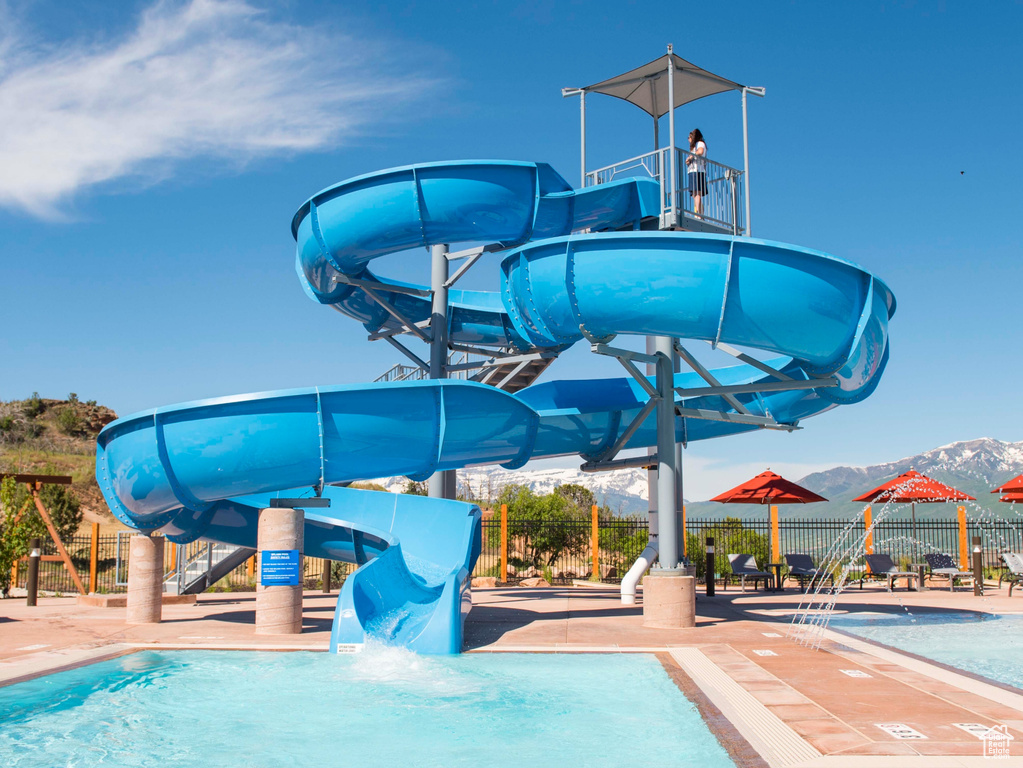 Community pool featuring a water slide