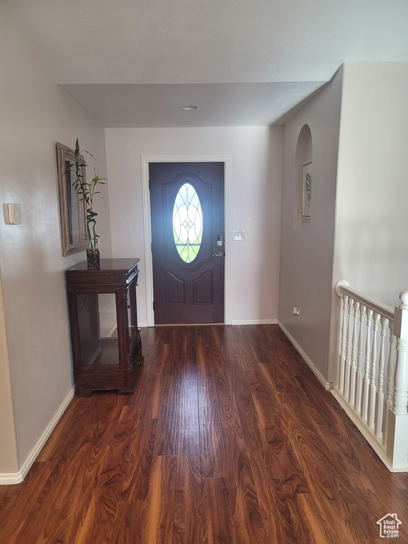 Foyer entrance featuring baseboards and wood finished floors