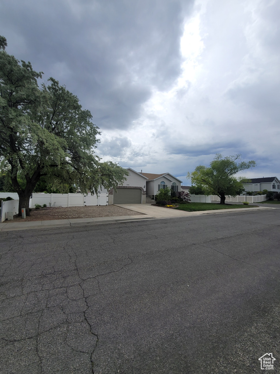 Obstructed view of property with concrete driveway and an attached garage