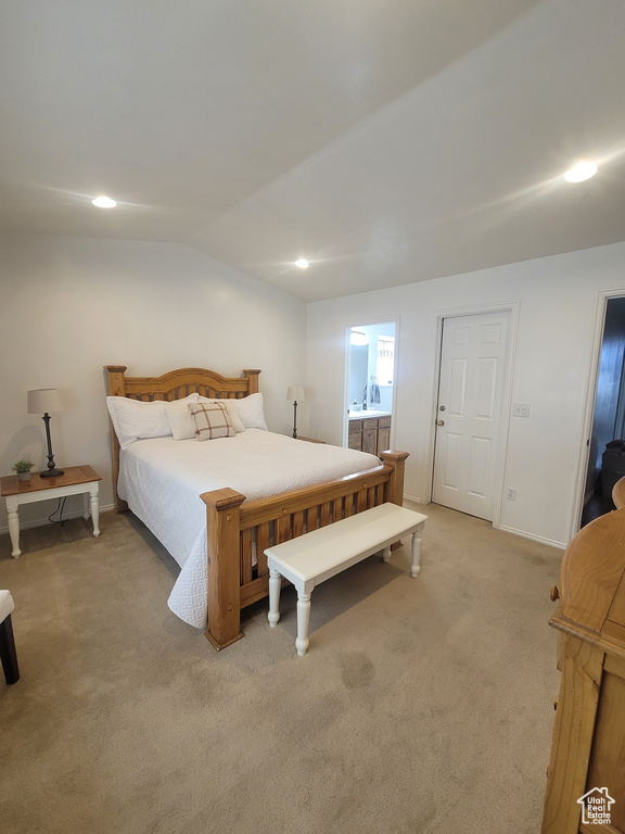 Bedroom with light carpet, lofted ceiling, ensuite bath, recessed lighting, and baseboards