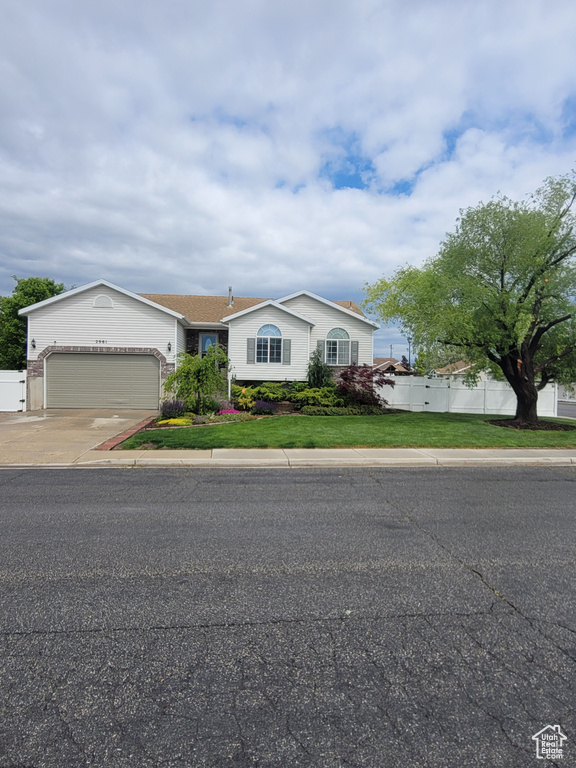 Ranch-style house with a garage and concrete driveway