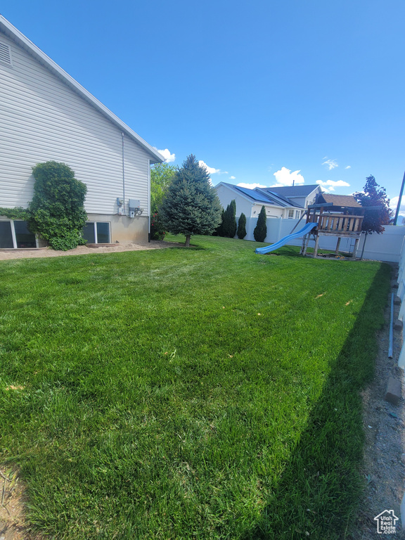 View of yard with a playground and cooling unit