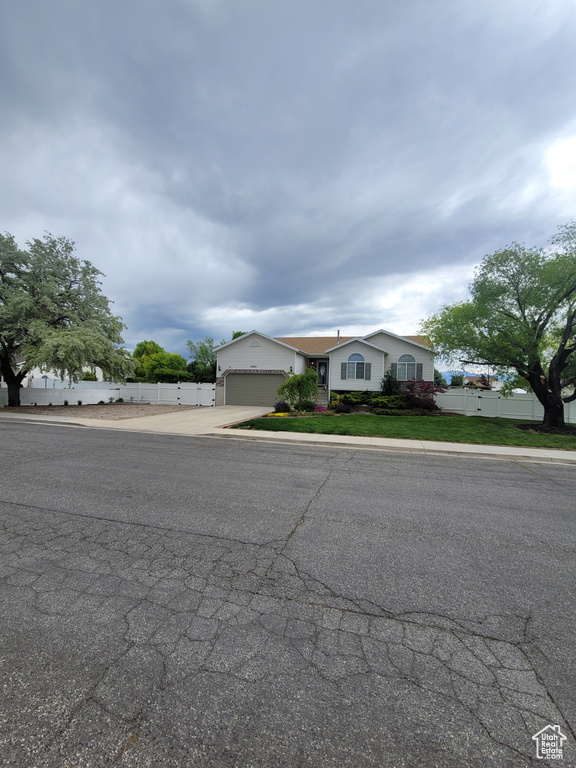 View of front of house featuring concrete driveway and a garage