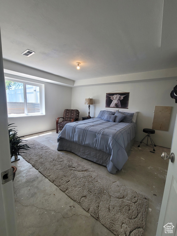 Bedroom with concrete flooring