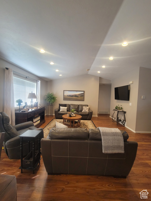 Living area featuring vaulted ceiling, baseboards, recessed lighting, and wood finished floors