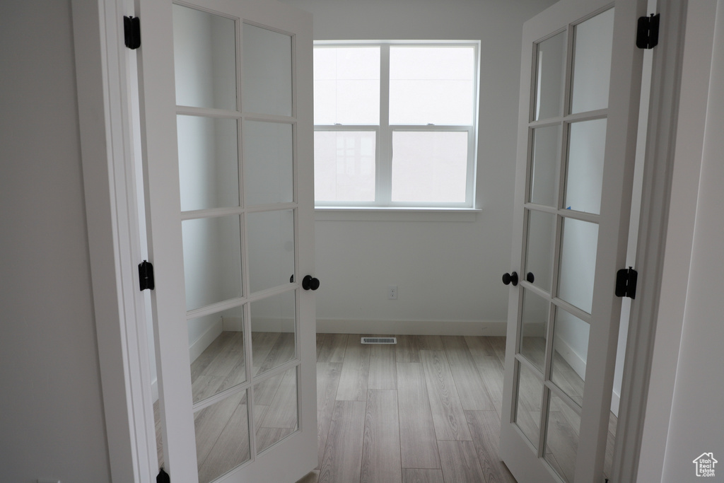 Empty room featuring wood finished floors and baseboards