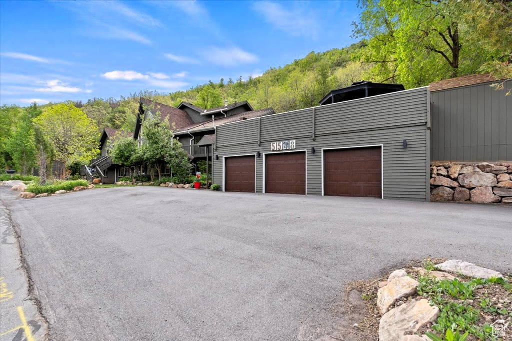 View of side of home featuring driveway