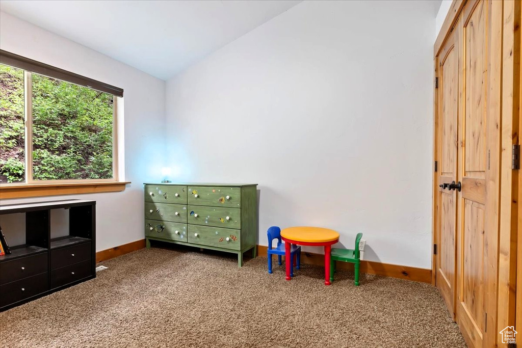 Playroom with carpet flooring, baseboards, and lofted ceiling