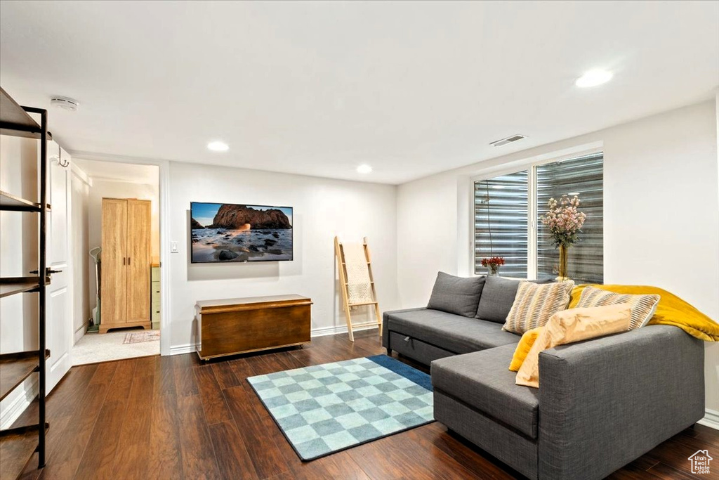 Living room with wood finished floors, recessed lighting, and baseboards