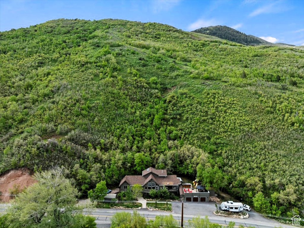 View from above of property featuring a heavily wooded area and mountains