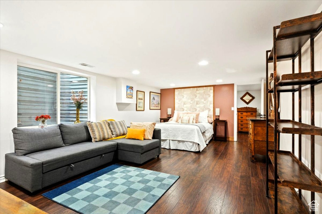 Bedroom featuring dark wood-style floors, recessed lighting, and baseboards
